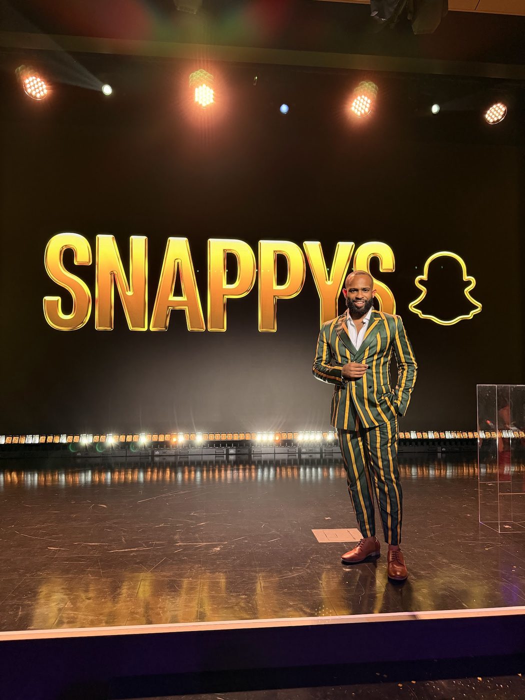 Trevor Queen speaking on stage at the Snappys awards